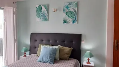 a bedroom with a bed with two pictures on the wall at OCEANUS ROOM With private kitchen, bathroom and terrace 300m from the beach in Sagres