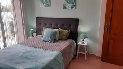 a bedroom with a large bed with two lamps at OCEANUS ROOM With private kitchen, bathroom and terrace 300m from the beach in Sagres