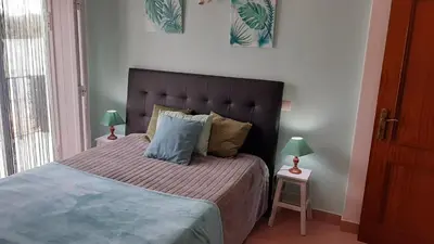 a bedroom with a large bed with two lamps on tables at OCEANUS ROOM With private kitchen, bathroom and terrace 300m from the beach in Sagres
