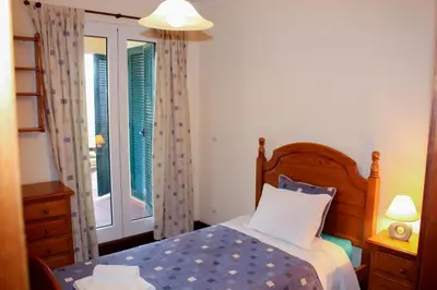 a bedroom with a bed and a window at Vista Formosa Funchal in Funchal