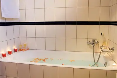 a bathroom with a bath tub with candles in it at Vista Formosa Funchal in Funchal