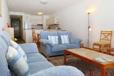 a living room with two blue couches and a table at Formosa Sunset - Em frente à praia com wifi in Panasqueira