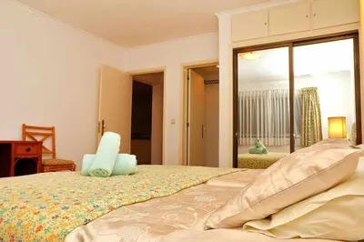 a bedroom with a bed and a large window at Formosa Sunset - Em frente à praia com wifi in Panasqueira