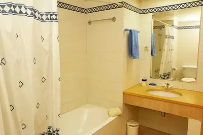 a bathroom with a tub and a sink and a shower at Formosa Sunset - Em frente à praia com wifi in Panasqueira