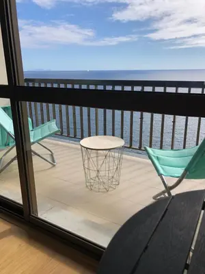 a balcony with a table and chairs and a view of the ocean at Bahia Top Floor in Funchal