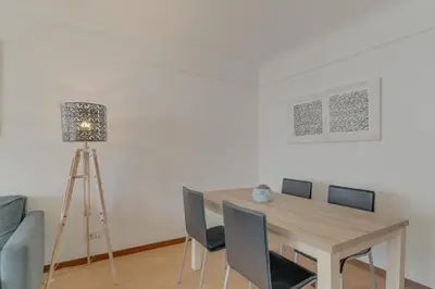 a dining room table with chairs and a lamp at Bahia Top Floor in Funchal