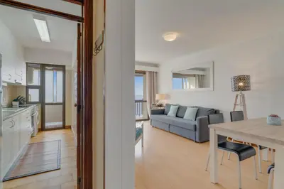 a kitchen and living room with a table and a couch at Bahia Top Floor in Funchal