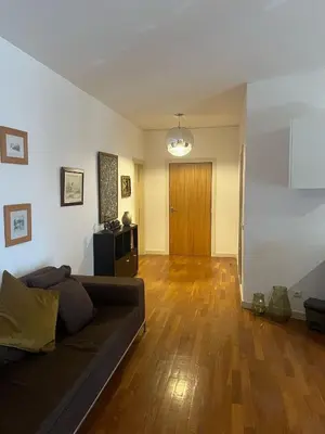 a living room with a couch and a wooden floor at Rocha Mar 3M in Ribeira Brava