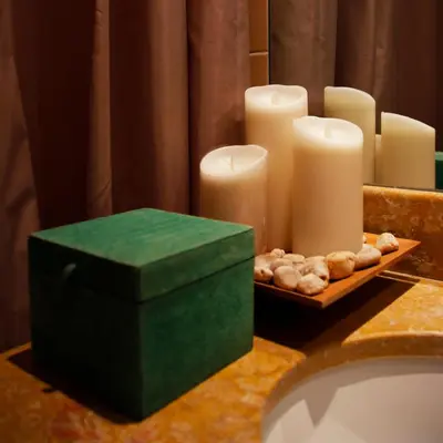 a bathroom counter with candles and a tray of cookies at Rocha Mar 3M in Ribeira Brava
