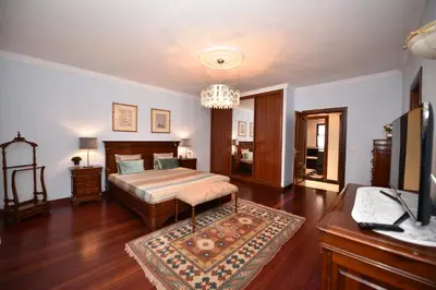 a bedroom with a bed and a desk and a television at Villa Santana in Funchal