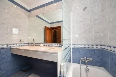 a bathroom with a sink and a tub and a shower at Villa Santana in Funchal