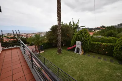 a balcony with a play yard with a slide at Villa Santana in Funchal
