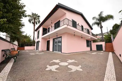 a house with a drawing on the ground in front of it at Villa Santana in Funchal