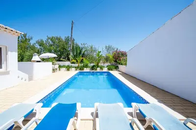 a villa with a swimming pool and lounge chairs at Monte Sao Pedro - Villa in Luz