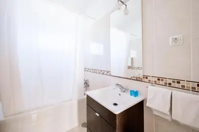 a white bathroom with a sink and a mirror at Monte Sao Pedro - Villa in Luz