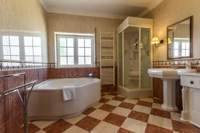 a bathroom with a tub and a shower and a sink at Casa Clementina in Lagos