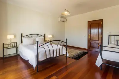 a bedroom with a bed and a wooden floor at Casa Clementina in Lagos