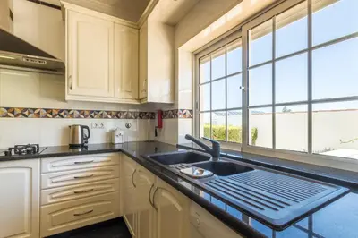 a kitchen with a sink and a window at Casa Clementina in Lagos