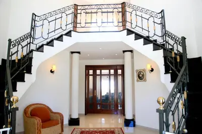 a staircase leading up to a house with a wooden door at Casa Clementina in Lagos