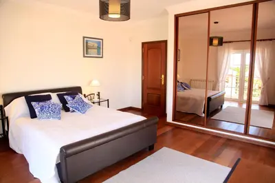 a bedroom with a bed and a mirror at Casa Clementina in Lagos