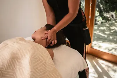 a woman getting a massage from a mans head at Monte Da Vilarinha in Carrapateira