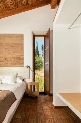 a bedroom with a bed and a large window at Monte Da Vilarinha in Carrapateira