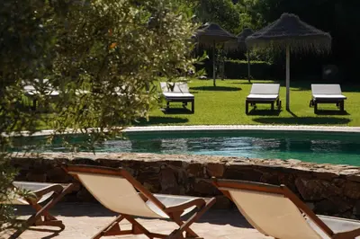 a couple of chairs and a swimming pool at Monte Da Vilarinha in Carrapateira