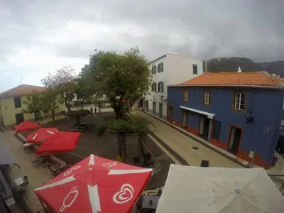 a group of umbrellas on a street with buildings at Albergaria O Professor in Santa Cruz