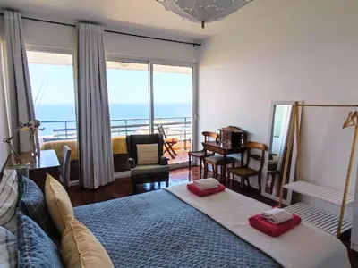 a bedroom with a bed with a view of the ocean at The Lidosol - Phenomenal view over the Atlantic Ocean in Funchal