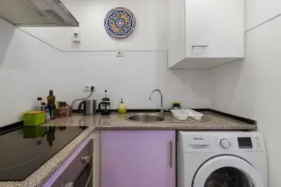 a kitchen with a washing machine and a sink at The Lidosol - Phenomenal view over the Atlantic Ocean in Funchal