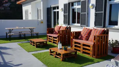 a patio with two chairs and a table at Apartamento Barros in Estreito de Câmara de Lobos