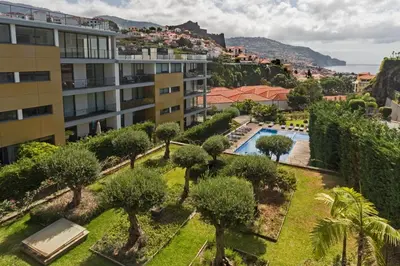 an aerial view of a building with trees and a swimming pool at Piscina fantástica no centro da cidade! in Funchal