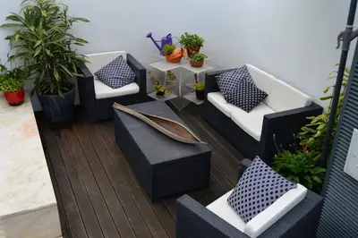 a patio with couches and a table and plants at vista dos arrifes in Funchal