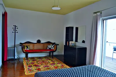 a bedroom with a bed and a rug on the floor at vista dos arrifes in Funchal