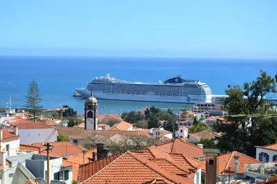 a cruise ship is docked in a city at vista dos arrifes in Funchal
