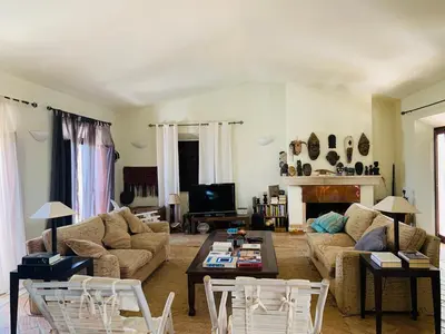 a living room with a couch and a table at Dona Maria 66 in Luz