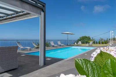 a swimming pool on the roof of a house at Villa Panoramica II in Arco da Calheta