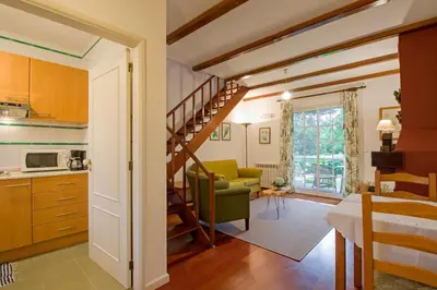 a kitchen and living room with a spiral staircase at Quinta Santo Antonio Da Serra in Santa Cruz