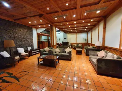 a large living room with couches and a table at Hotel Jardim Atlantico in Calheta