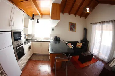 a kitchen and living room with a counter top at Casa da Rainha Bungallow in Estreito da Calheta