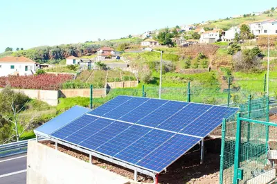 a group of solar panels on top of a building at Casa da Rainha Bungallow in Estreito da Calheta