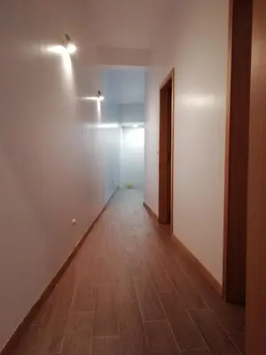 an empty hallway with white walls and a wooden floor at Sweet Home for Holidays in Machico