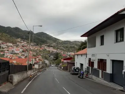 an empty street in a small town with houses at Sweet Home for Holidays in Machico