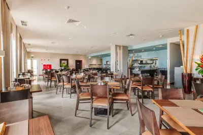 a dining room with tables and chairs at Enotel Sunset Bay in Ponta do Sol