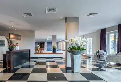 a lobby with a black and white checkered floor at Enotel Sunset Bay in Ponta do Sol