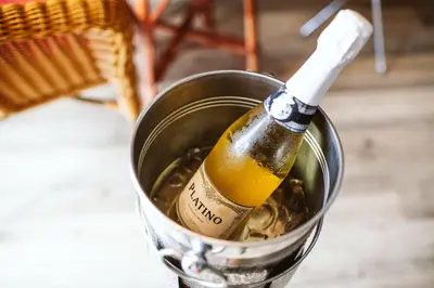 a bottle of beer in a bucket on a table at Enotel Sunset Bay in Ponta do Sol
