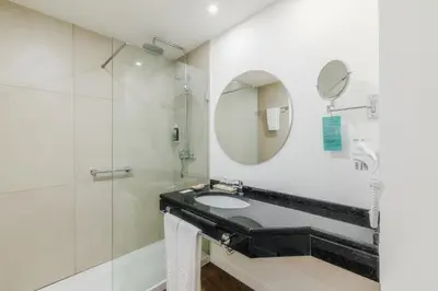 a bathroom with a sink and a mirror at Enotel Santo da Serra in Santo da Serra