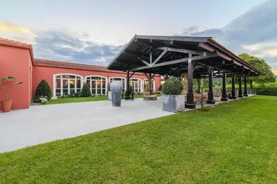 a pavilion in front of a red building at Enotel Santo da Serra in Santo da Serra