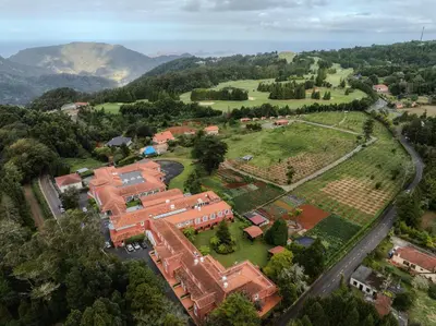 an aerial view of a school campus with mountains in the background at Enotel Santo da Serra in Santo da Serra
