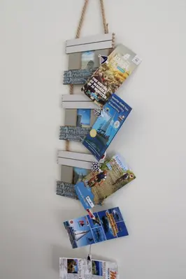 a christmas tree made out of magazines on a wall at Refugio Madeira in Caniço